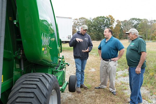 Brian Lanoue talking with local farmers about issues affecting agriculture.